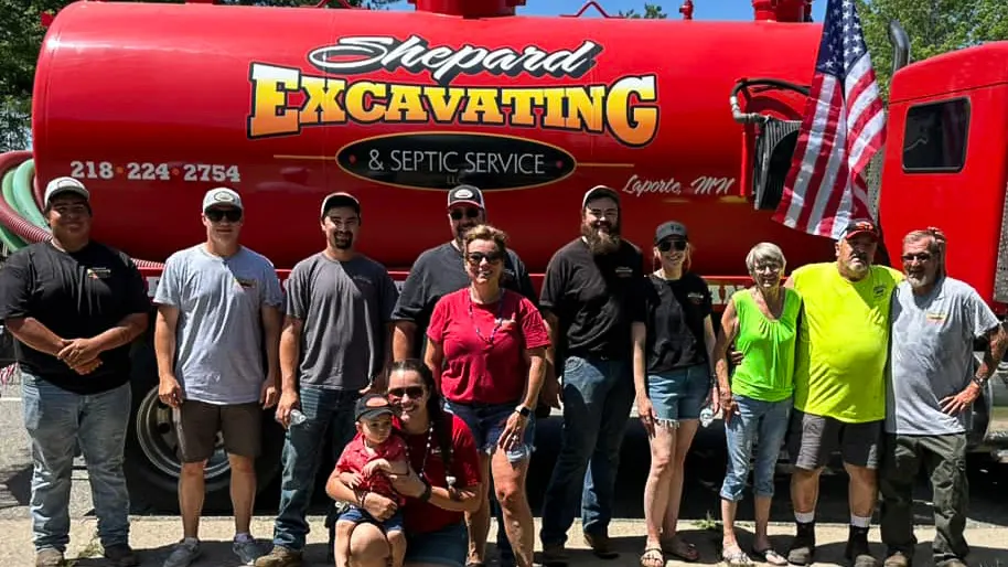 The Shepard Excavating and Septic Service team in front of a company truck