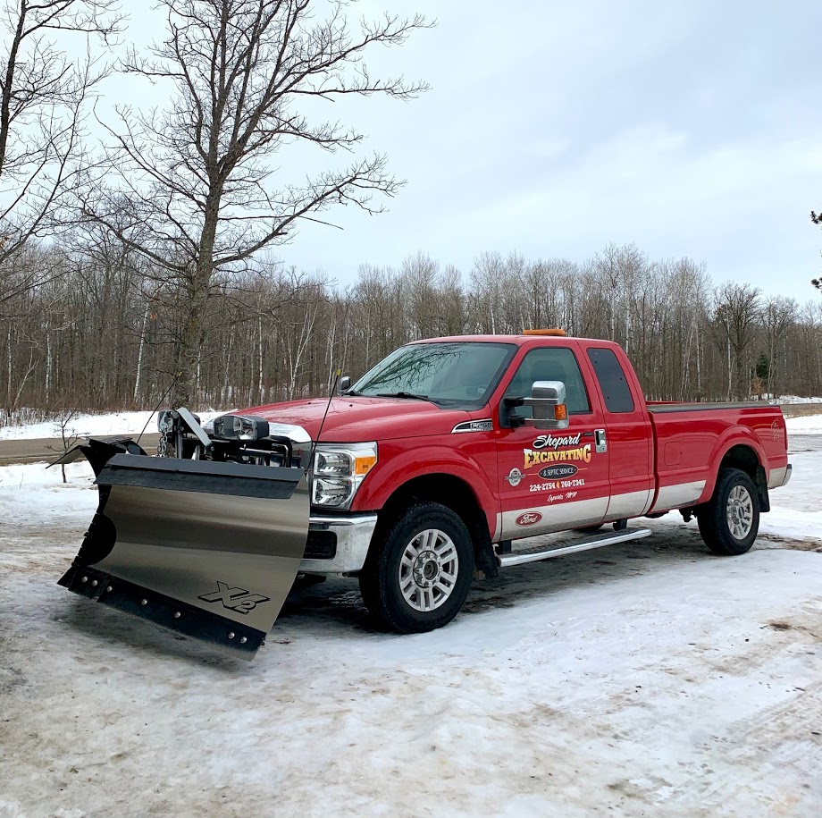 A Fisher XV2 V-plow mounted on a pickup at the Shepard Excavating shop